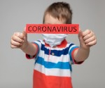 Young child wearing a respiratory mask as a prevention against the Coronavirus Covid-19